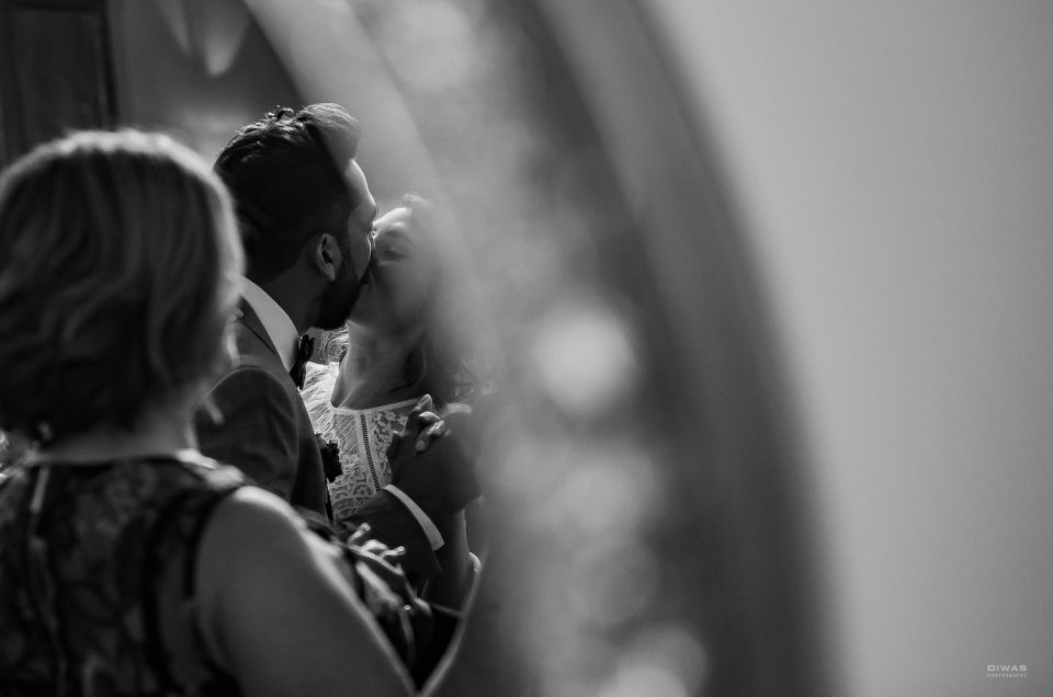 Relaxed Lake Washington wedding candid black and white photograph of ceremony kiss